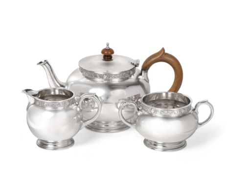 A Three Piece Silver Tea Service, Reid & Sons, London 1965, spherical form on short foot, with Celtic knot border, the teapot