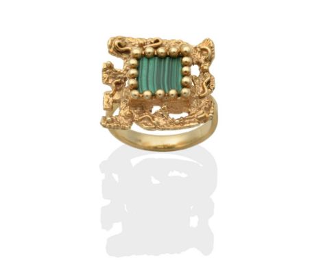 A Malachite Ring, a square malachite plaque in a beaded claw setting, within a textured square frame, finger size K see illus