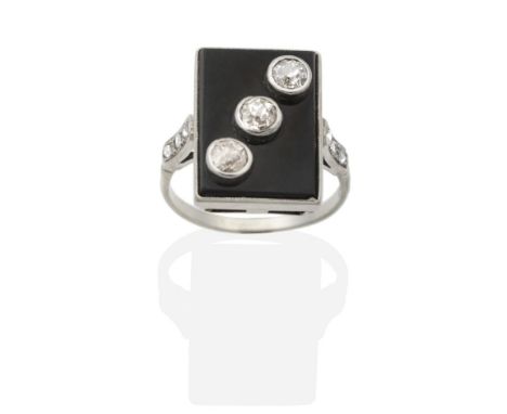 An Art Deco Onyx and Diamond Ring, a rectangular onyx plaque with three old cut diamonds in milgrain settings, to diamond set