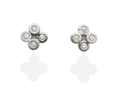 A Pair of Diamond Earrings, four round brilliant cut diamonds in rubbed over settings, total estimated diamond weight 0.20 ca