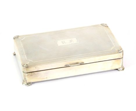 An Art Deco Silver Cigarette Box, marks rubbed, Birmingham possibly 1934, rectangular with stylised corners and bracket feet,