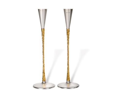 Stuart Devlin: A Pair of Parcel Gilt Silver Candlesticks, London 1972, the slender tapering stem with textured decoration, on