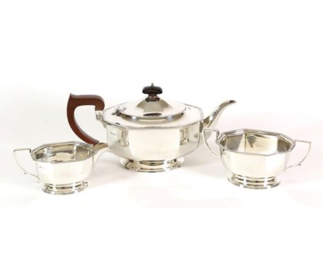 An Art Deco Three Piece Silver Tea Service, Adie Bros, Birmingham 1940, oval octagonal form on pedestal foot with straight ga