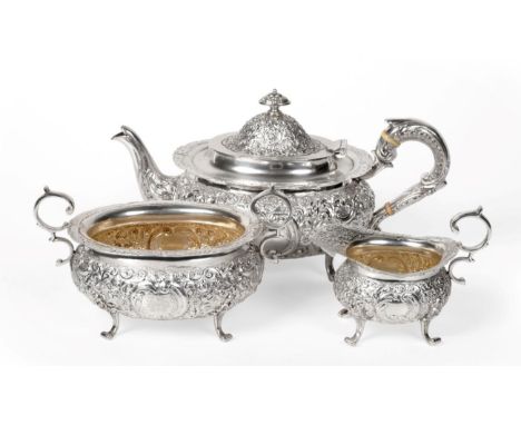 A Late Victorian Scottish Silver Three Piece Tea Service, George Edward & Sons, Glasgow 1900, oval form, chased with dense sc