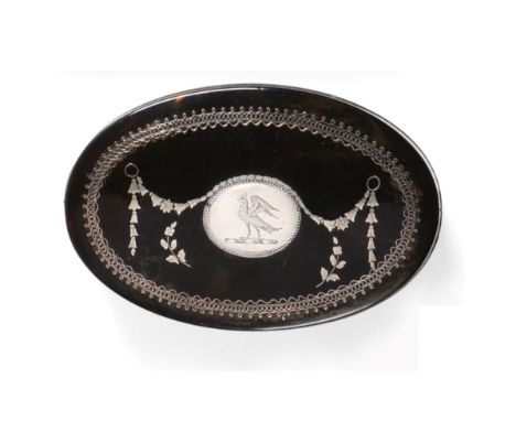 A George III Tortoiseshell and Silver Pique Work Snuff Box, circa 1790/1800, oval, the lift off cover with a central crest of