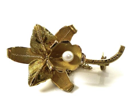 An 18ct gold brooch in the shape of an orchid, set with a pearl to the centre, 3.8cm long, safety chain, marked 18K, 3.9g, wi