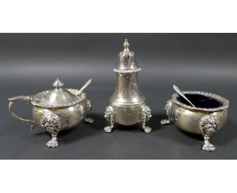 An Elizabeth II silver three piece cruet set, comprising tower pepperette, the removable finialled top with cross and scrolle