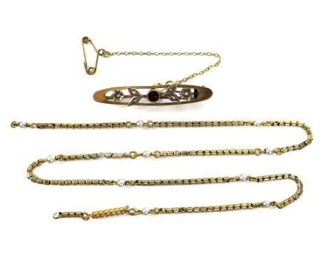 A 9ct gold, ruby and seed pearl brooch, 4cm long, with safety chain, 2.9g, boxed, together with a gold necklace, a/f, unmarke