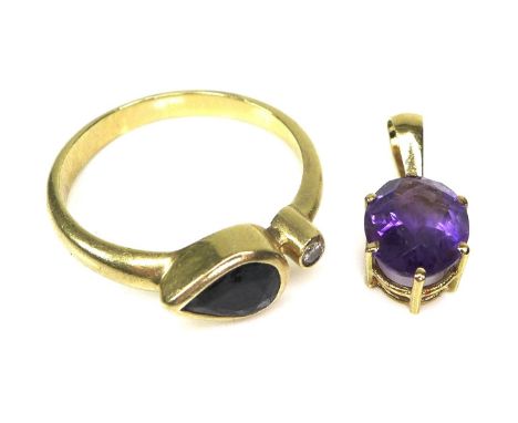 A 18ct gold, sapphire and diamond ring of unusual design, formed of a pear cut sapphire, of dark colour and approximately 0.8