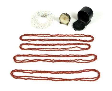 Four coral bead necklaces, three of them 58cm long, the last slightly shorter at 53cm, together with a Looping travel alarm c