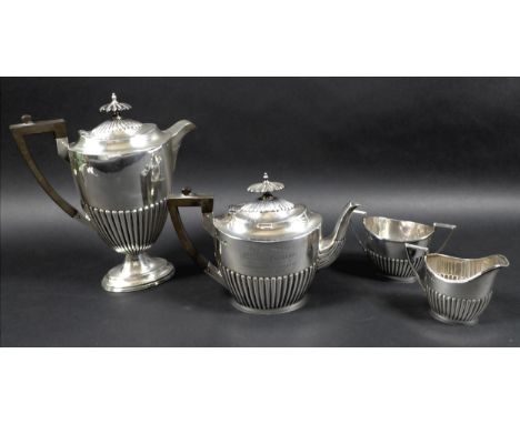 A George V four piece silver tea service, all with half reeded lower bodies, comprising a teapot with presentation engraving 