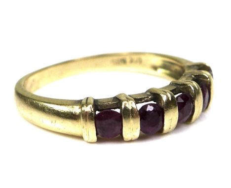 A 14ct gold and ruby half eternity ring, formed of five round cut rubies, each of approximately 2.5mm diameter, intersected b