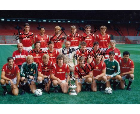 Autographed MAN UNITED 1985 ; Col photo measuring 12 x 8 depicting Man United players posing with the FA Cup during a photo-s
