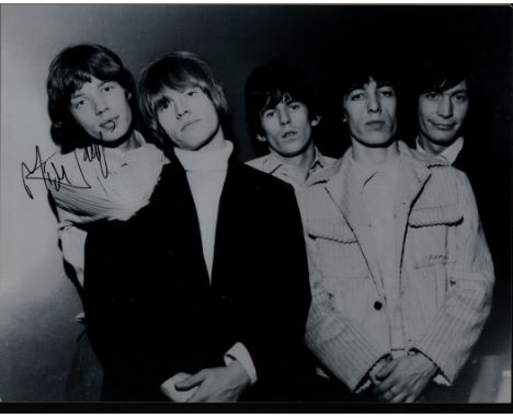 Mick Jagger signed 14x12inch black and white Rolling Stones photo.. Good condition. All autographs come with a Certificate of
