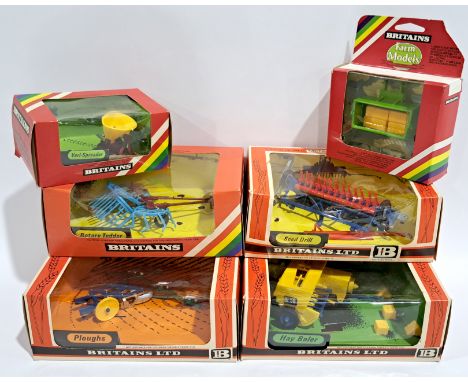 Britains Tractor Accessories 9539, 9563, 9541, 9546 &amp; 9538,&nbsp;a boxed group. Seed Drill, Hay Baler, Rotary Tedder, Plo