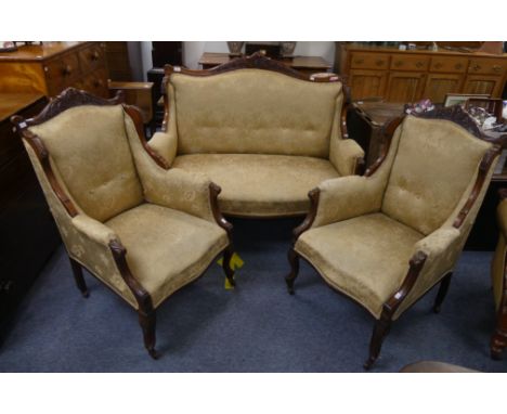 An Edwardian mahogany-framed two-seater Salon Sofa, the carved top rail above the cream and golden upholstery with foliate de