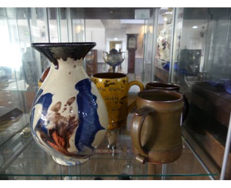 A small quantity of Studio Pottery; comprising two Leach Pottery Tankards, one decorated with brown glaze, the other in green