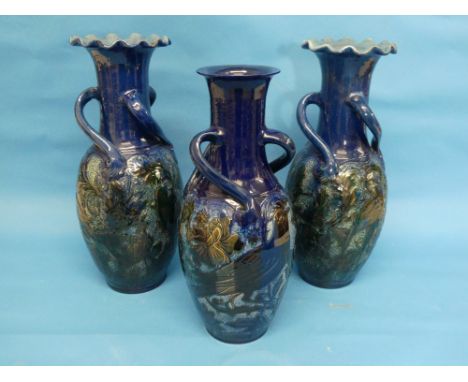 A pair of Alexander Lauder (Barnstaple) pottery vases, of oviform form with raised neck and wavy rim and three scroll handles