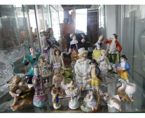 A quantity of Figurines, mostly continental porcelain figural groups, but also including Hummel, pottery birds etc. (a lot)