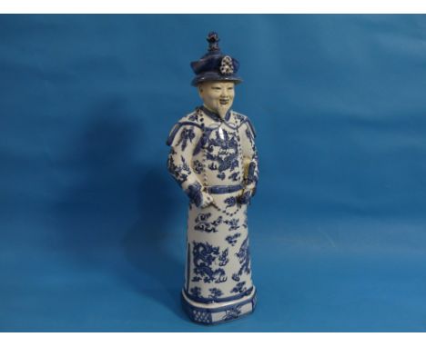 A 20th century Chinese blue and white porcelain figure of an Elder, behatted and holding a pipe, his robes decorated with dra