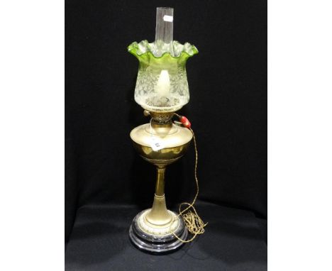     A Circular Based Brass Column Oil Lamp With Green Tinted Shade                  