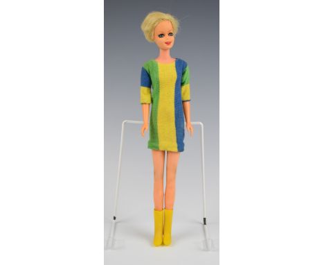 Mattel Twiggy Barbie doll wearing a blue/green/yellow striped dress and yellow boots, c.1967, height 27cm.