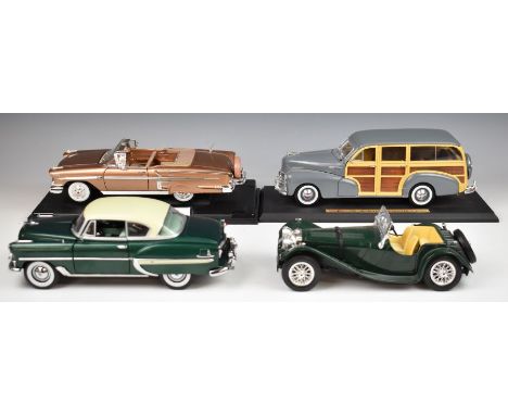 Four 1:18 scale diecast model cars including Maisto 1948 Chevrolet Fleetmaster (Woody).