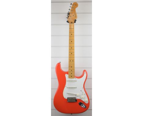 Fender Stratocaster vintage series electric guitar in custom orange, with maple neck and fretboard, serial number V011977, ma