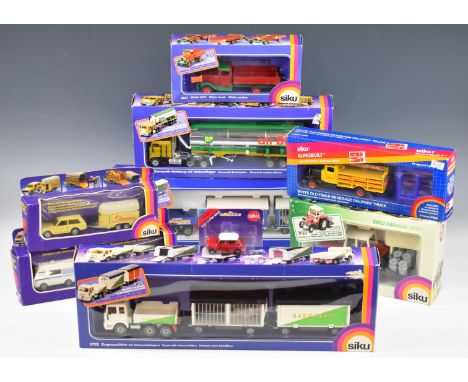Nine Siku diecast model trucks and cars to include Kenworth Semi Tanker BP 3418 and Camper with Caravan 2518, all in original