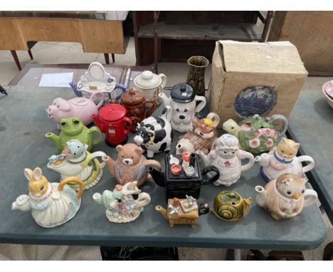 A LARGE ASSORTMENT OF NOVELTY CERAMIC TEAPOTS AND A COLLECTION OF BLUE AND WHITE PLATES 