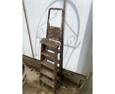 A VINTAGE WOODEN FOUR RUNG STEP LADDER AND A FOUR RUNG METAL STEP LADDER 