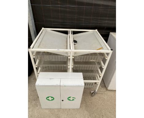 A FOUR WHEELED DRAWER STORAGE UNIT AND A FIRST AID CUPBOARD 