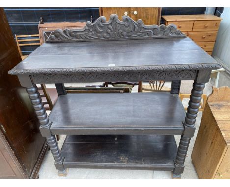 A VICTORIAN OAK THREE TIER BUFFET WITH TURNED UPRIGHTS AND RAISED AND CARVED BACK PANEL, 48" WIDE 