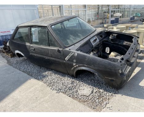 A FORD FIESTA XR2 3 DOOR SALLON CAR FOR A RESTORATION PROJECT COMPLETE WITH VARIOUS SPARE PARTS TO INCLUDE WHEELS, ENGINE, AX