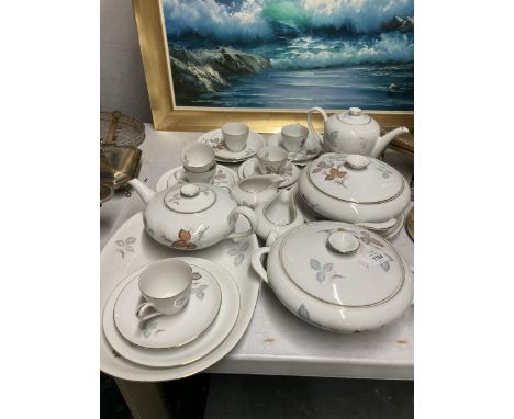 A QUANTITY OF GERMAN TEA AND DINNER WARE TO INCLUDE A TEA AND COFFEE POT, CREAM JUGS, SERVING TUREENS, CUPS, SAUCERS, PLATES,