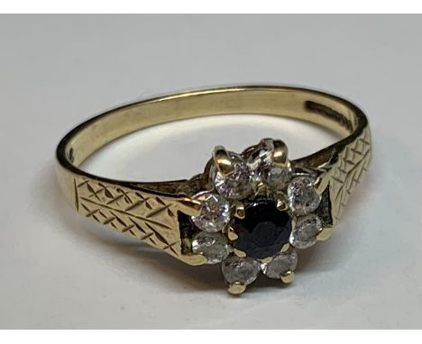 A 9 CARAT GOLD RING WITH CENTRE SAPPHIRE SURROUNDED BY CUBIC ZIRCONIA SIZE N/O 