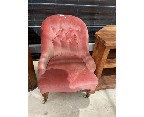 A VICTORIAN BUTTON BACK NURSING CHAIR ON TURNED FRONT LEGS 