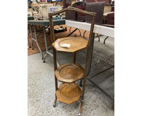 A VINTAGE OAK CAKE STAND WITH THREE HEXAGONAL TIERS 