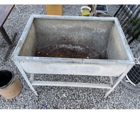 A LARGE GALVANISED WASH TROUGH ON STAND 