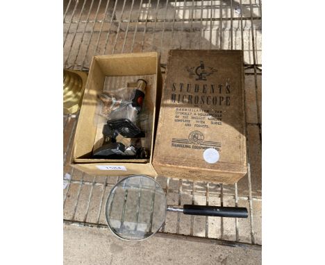 A VINTAGE BOXED STUDENTS MICROSCOPE AND A MAGNIFYING GLASS 