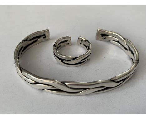 A MATCHING SILVER BANGLE AND RING SET 