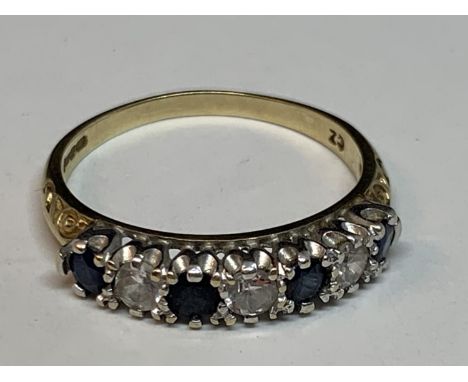 A 9 CARAT GOLD RING WITH FOUR SAPPHIRES AND THREE CUBIC ZIRCONIAS IN A LINE SIZE M/N 