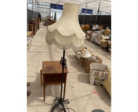 A WROUGHT IRON STANDARD LAMP COMPLETE WITH SHADE 