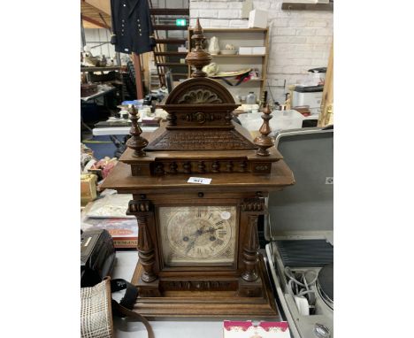 A LARGE MAHOGANY CASED MANTLE CLOCK WITH COLUMN CARVING, IN NEED OF RESTORATION 
