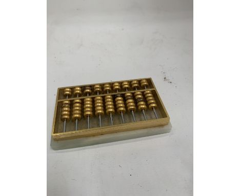 A SMALL ONYX AND BRASS ABACUS 