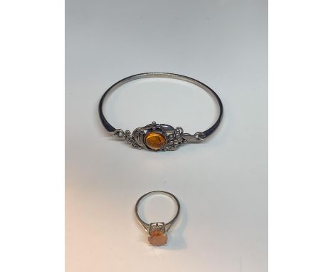 A SILVER BANGLE WITH AMBER STONE AND A MATCHING RING 