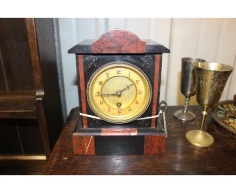 A late Victorian black slate and rouge marble mantle clock