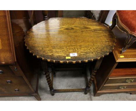 An oak barleytwist side table; together with a standard lamp and shade