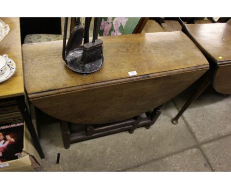 An antique oak gate leg dining table