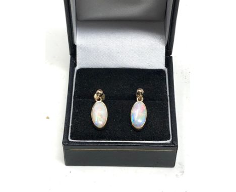 Fine 9ct gold opal earrings measure approx 1.9cm drop by 6.5cm wide opals measure approx 12mm by 6mm weight 2.1g